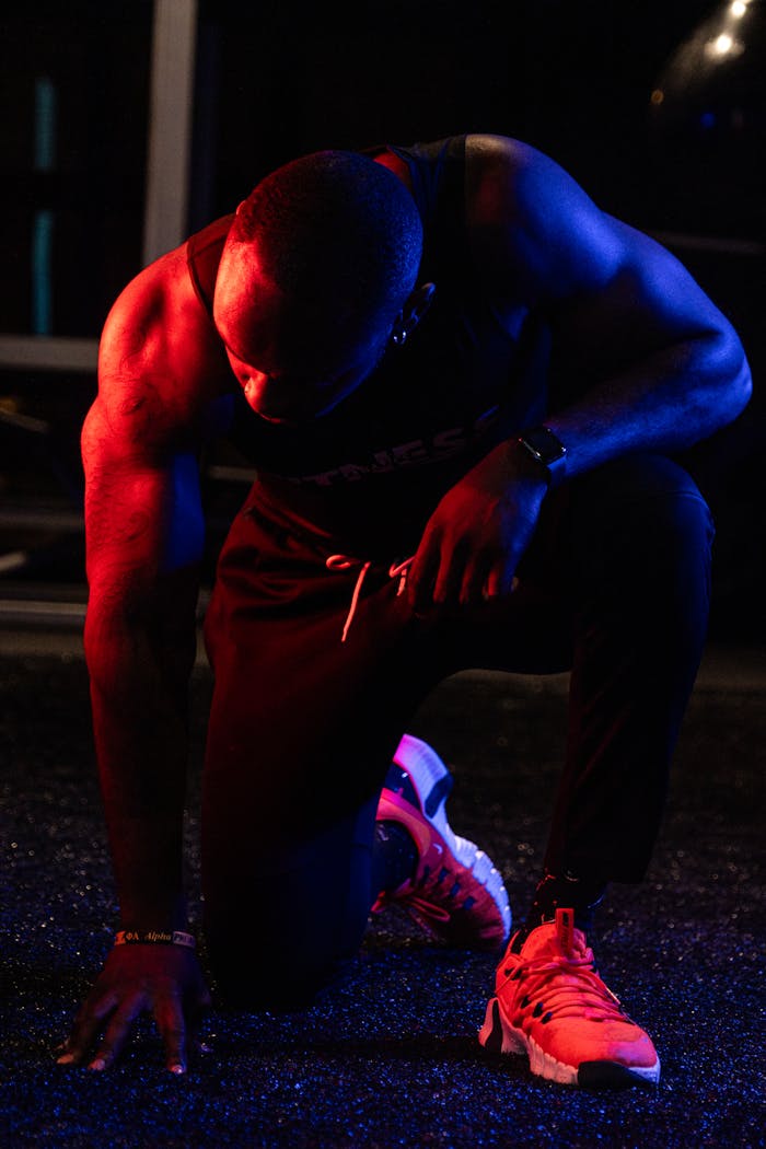 Powerful pose of an athlete in dynamic lighting, showcasing strength and determination.
